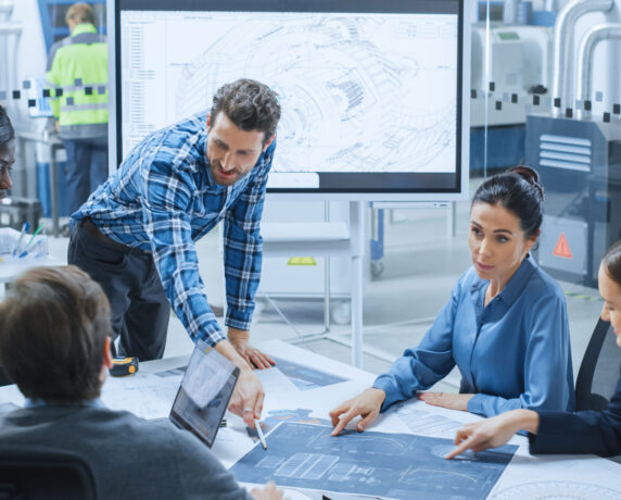 Engineer inspecting machinery components in an industrial facility.