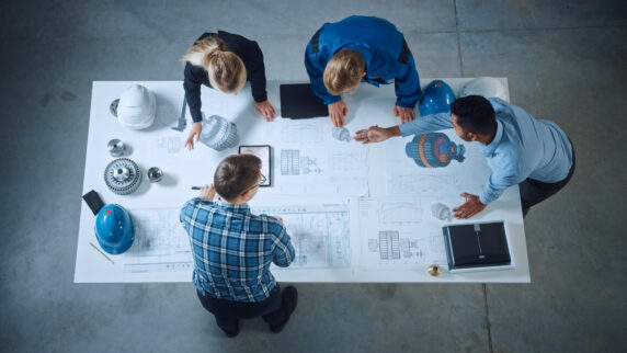 Team of engineers collaborating in a modern workspace.