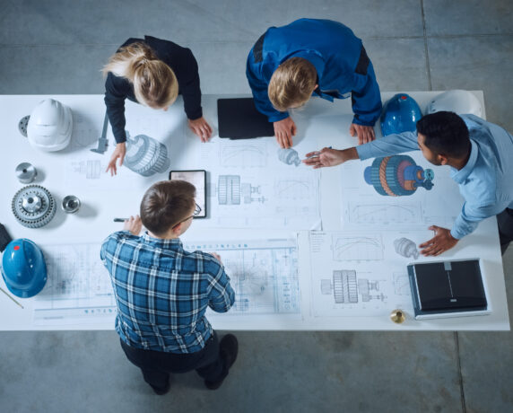 Team of engineers collaborating in a modern workspace.