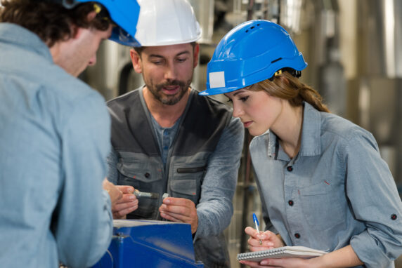 Engineers assessing bolted joint torque on industrial machinery.