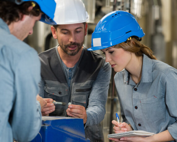 Engineers assessing bolted joint torque on industrial machinery.