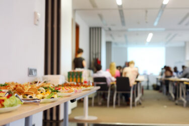 Refreshments and cold snacks arranged on table for business meeting.