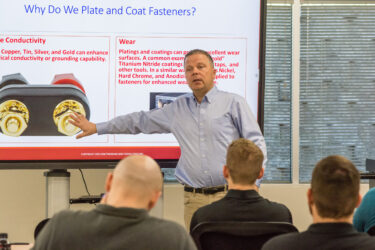 Jon Ness leading a technical training session in a classroom setting.