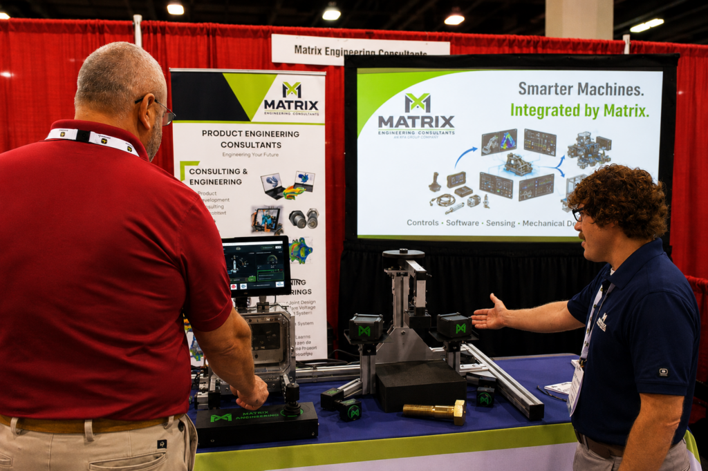 Product engineering consultant demonstrates bolted joint design and analysis at trade show booth.
