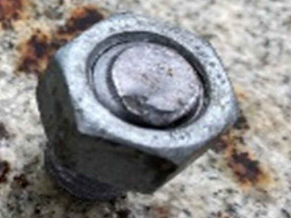Close-up of a failed bolt showing fracture surfaces.