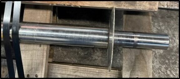 Close-up of a machined drive shaft with detailed grooves.