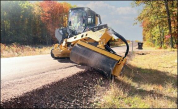 Vibratory roller machine compacting soil on a construction site.