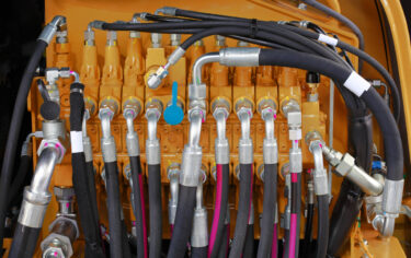 Engineer reviewing technical blueprints at a workstation.