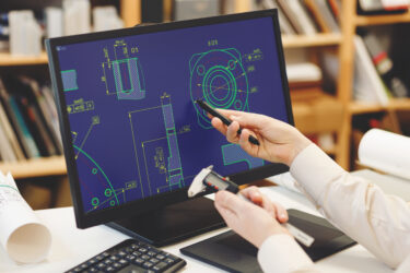 Engineer reviewing designs for new product development consultation.