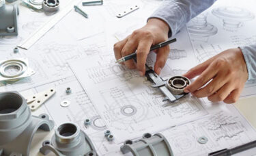 Engineer conducting root cause analysis on mechanical component failure.